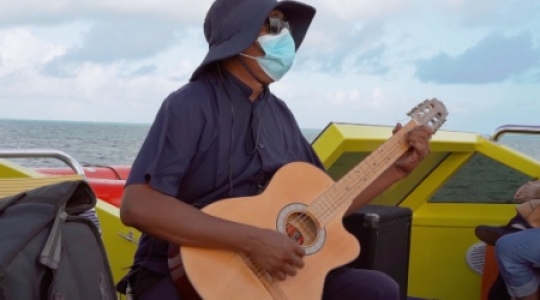 Isla Muieres masked guitar player on boat - 3