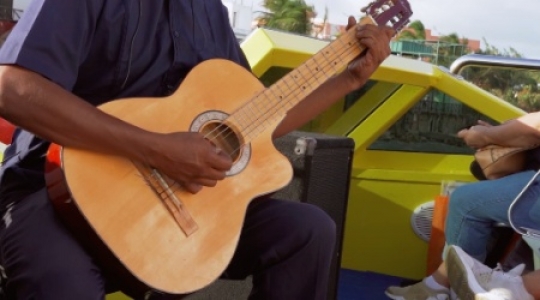 Isla Muieres masked guitar player on boat