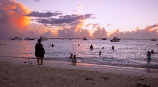 Isla Muieres people and boats at beach with sunset static shot - 1