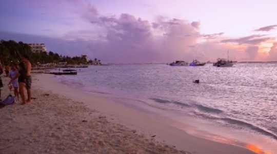 Isla Muieres people and boats at beach with sunset static shot - 3