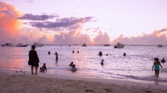 Isla Mujeres people and boats at beach with sunset static shot -1 slo mo 