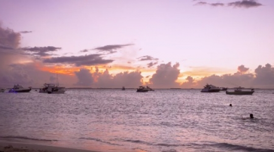 Isla Mujeres people and boats at beach with sunset wide static shot -1 