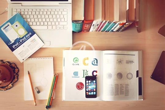 Laptop computer, phone, and books on the table