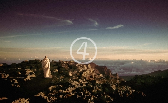 Woman wearing white dress on top of the mountain